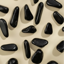 Pattern of black stones on a beige background